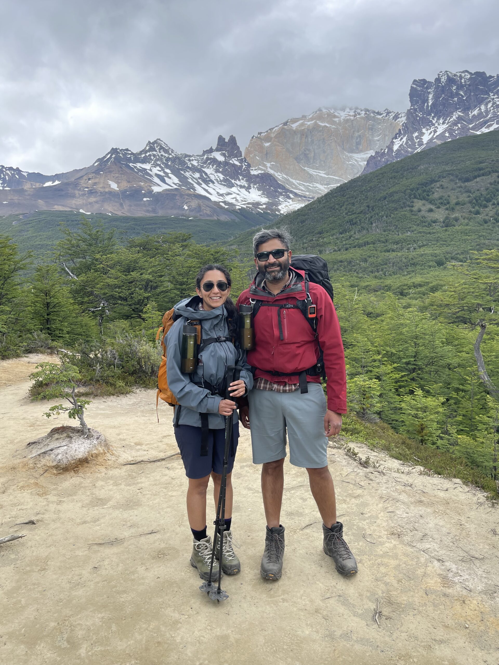 Couple poses for photo in Patagonia with a mountain in the background