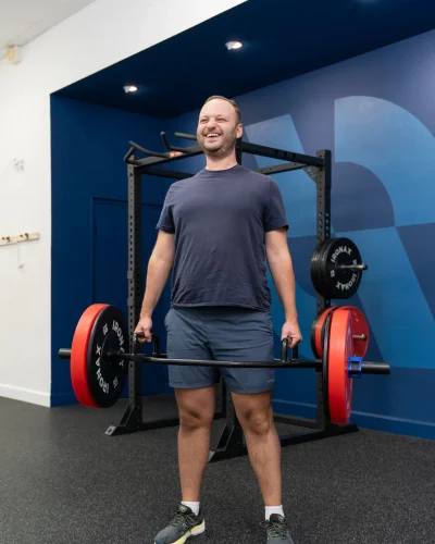 Person doing a deadlift with a hex barbell